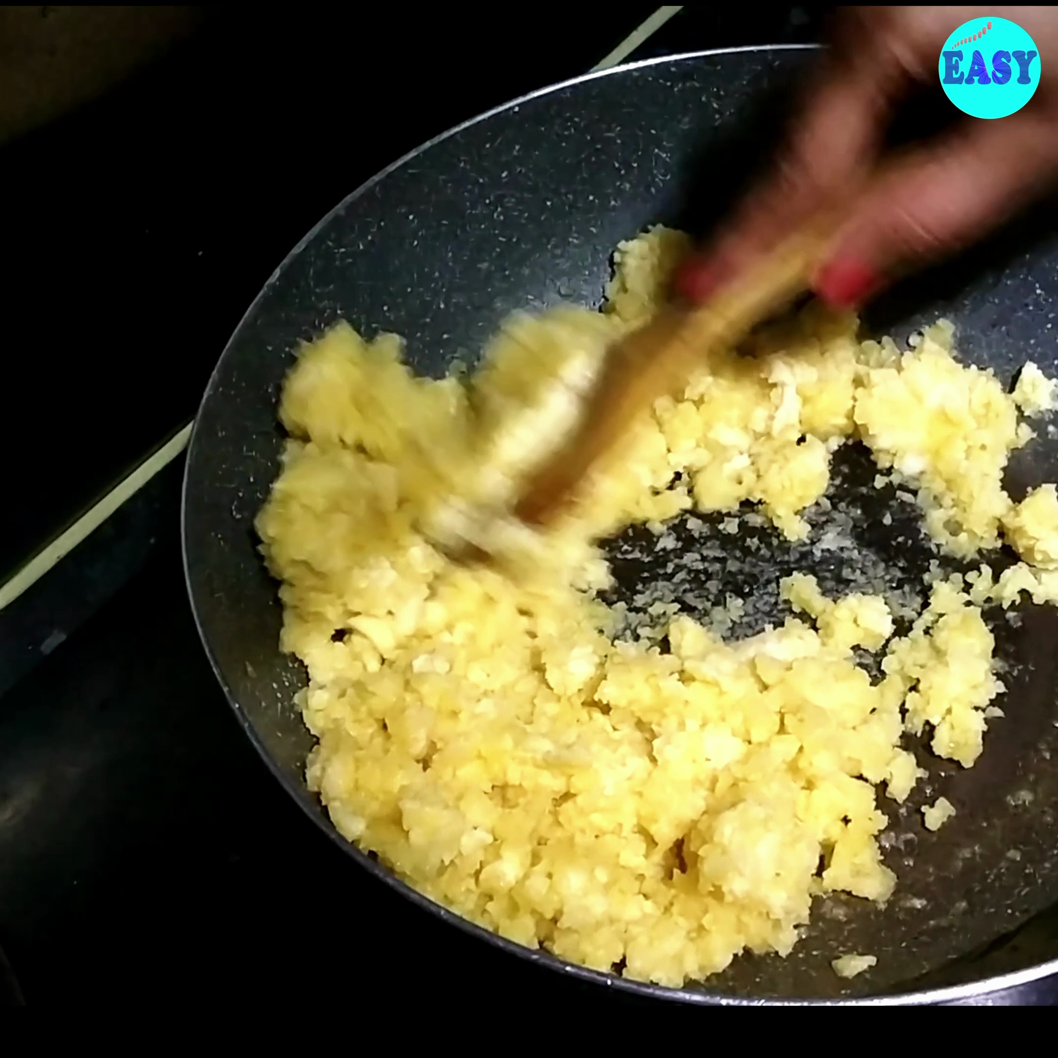 Step 7 - Cook the moong dal paste on low to medium heat, stirring continuously to prevent it from sticking to the bottom of the pan. This process will take some time (around15-25 minutes) as you need to cook the dal until it changes color to a golden brown and emits a pleasant aroma.