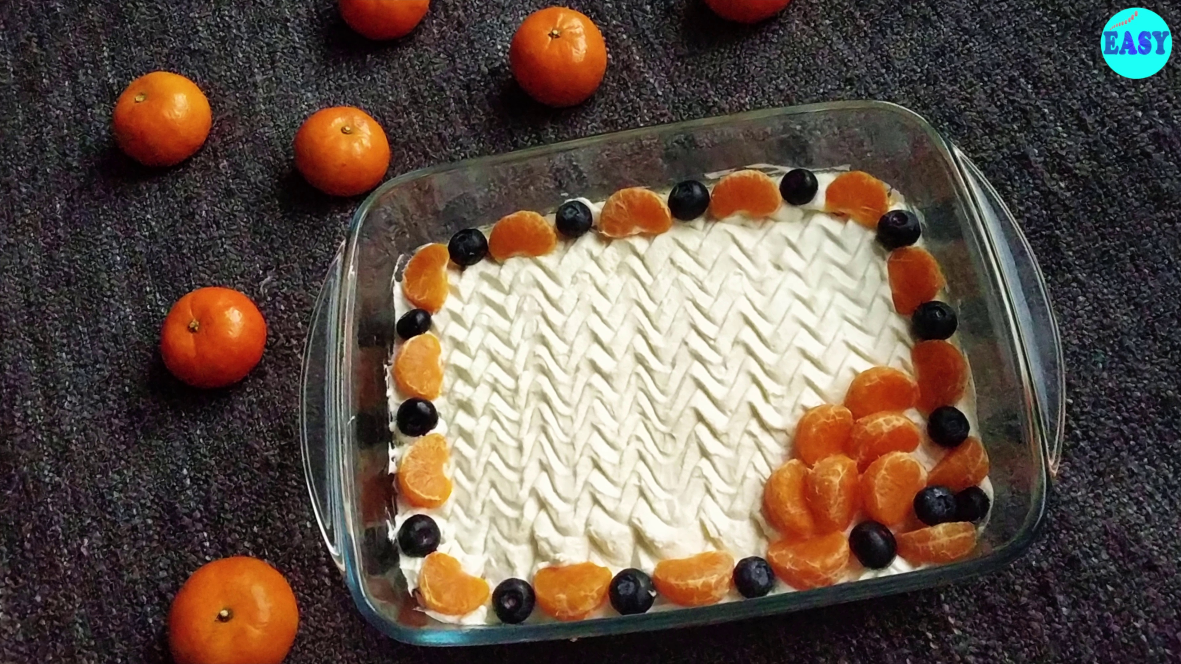 Step 10 - Spread some whipped cream on top and decorate with some fresh orange slices and blueberries.