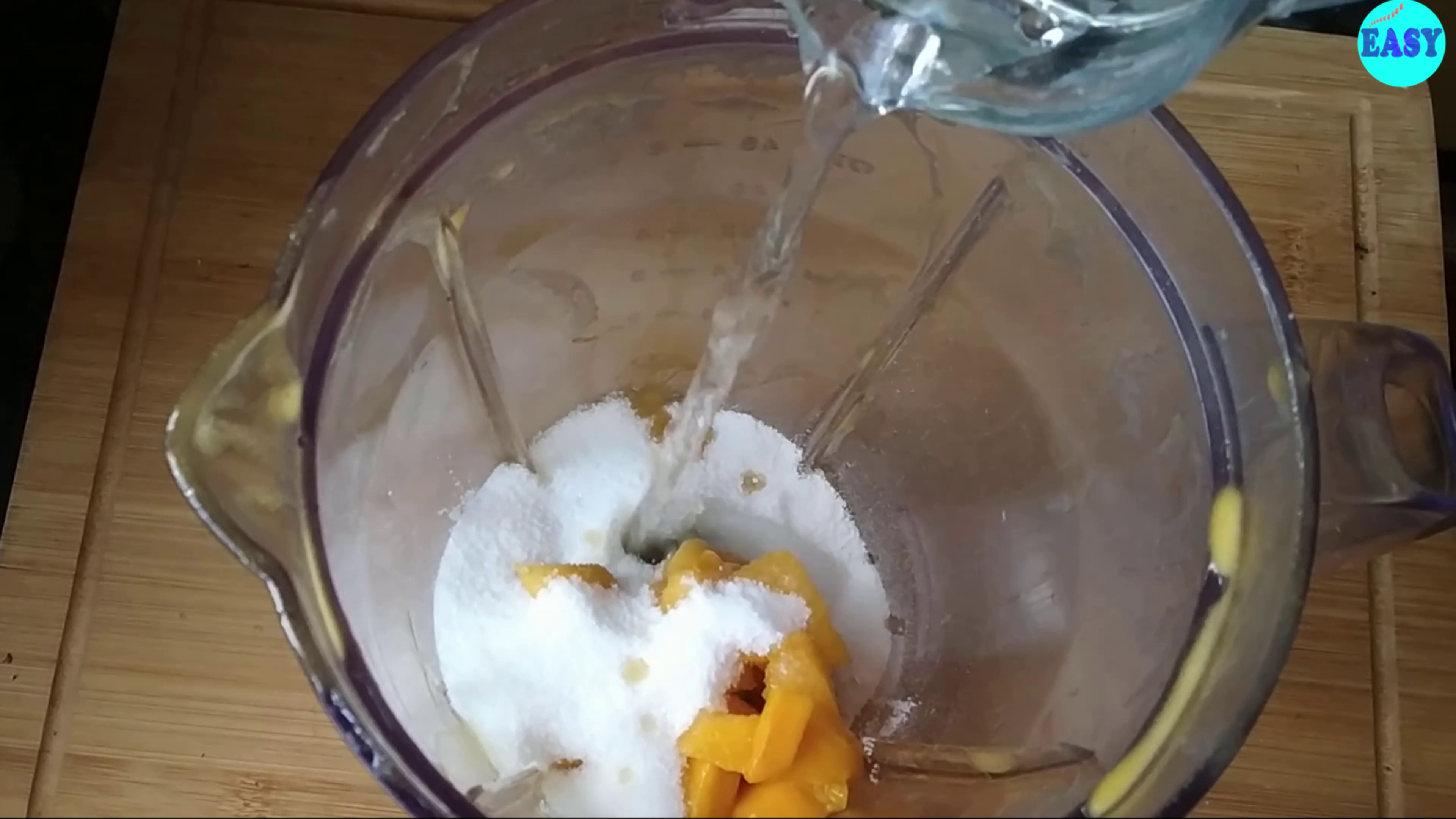 Step 10 - For the glace take mango pulp, sugar and water in a blending jar to make a smooth paste.