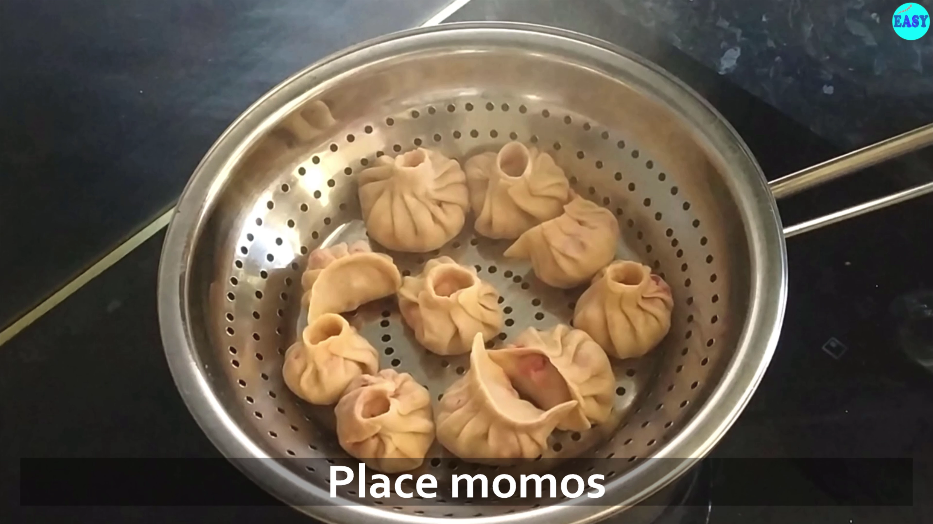 Step 13 - For steaming momos grease a strainer with some oil. Boil 1 -2 cup of water in a pan .Once it comes to a boil,place momos in strainer and steam for 12-15 min. 
