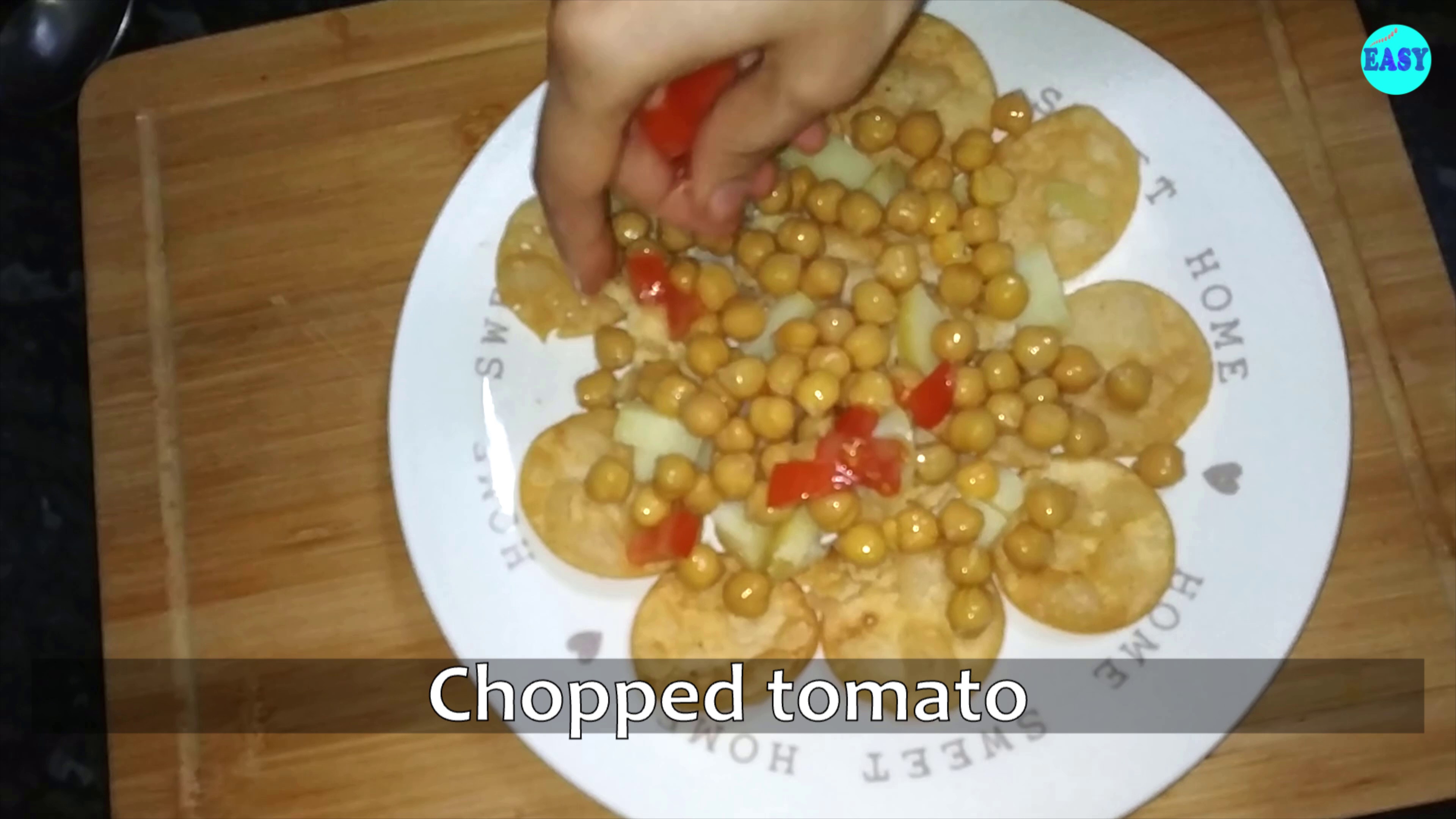 Step 14 - Spread the boiled potatoes and chickpeas over it. Add chopped tomatoes on top.