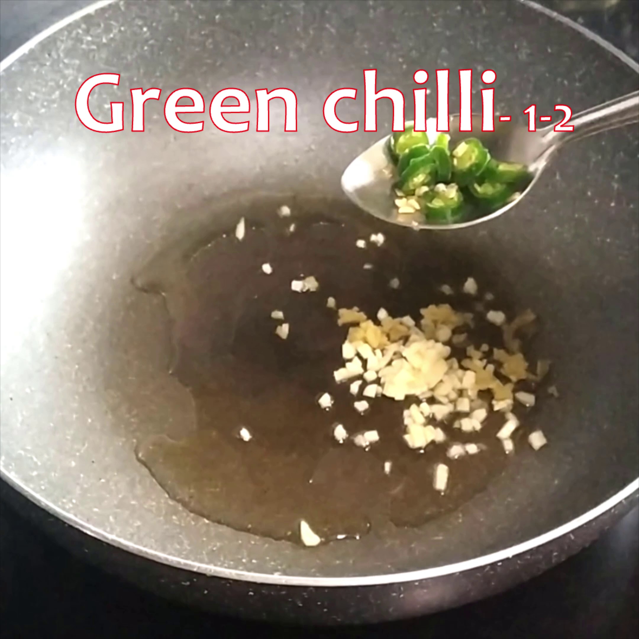 Step 2 - Heat oil in a pan and add chopped garlic, ginger and green chillies.
