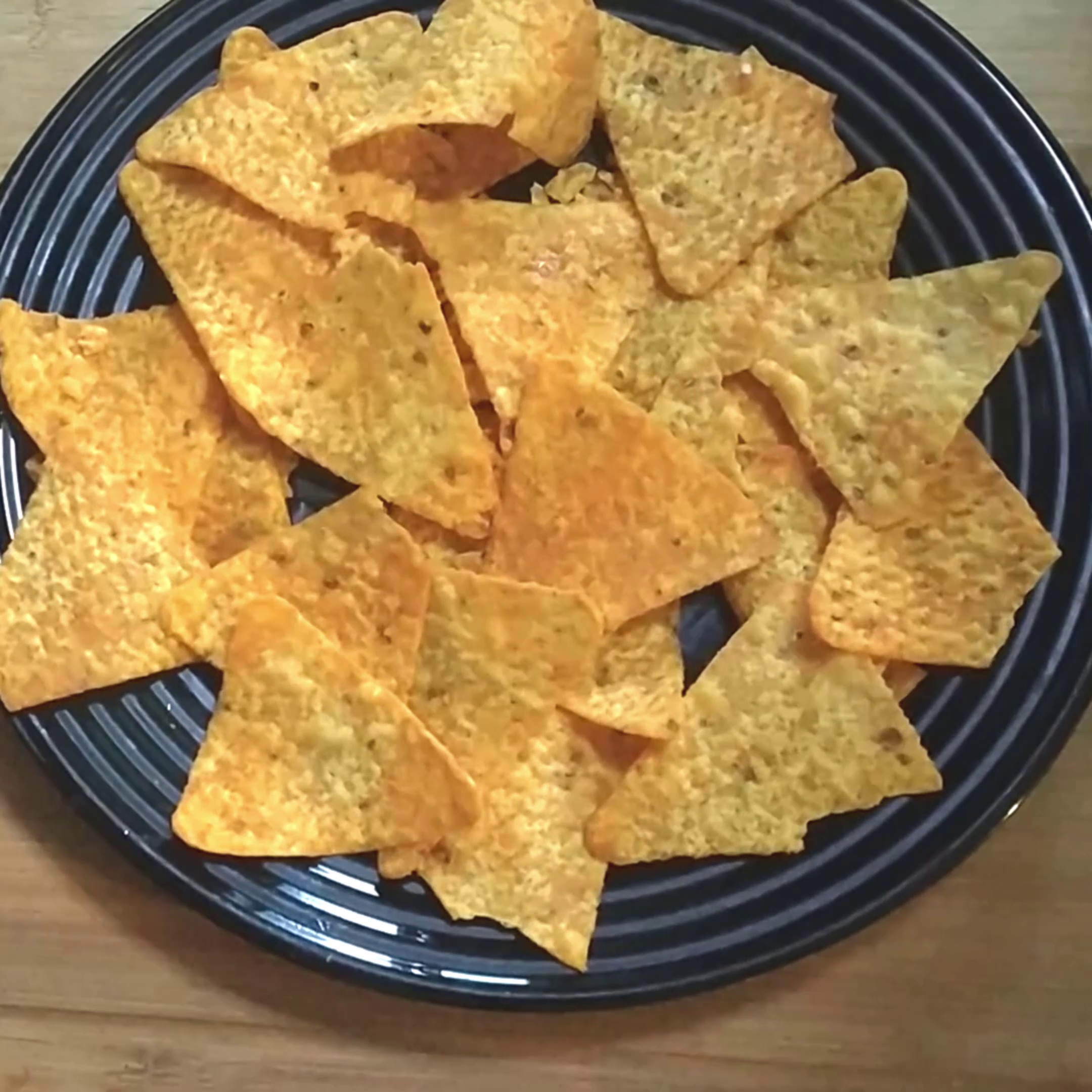 Step 1 - Take nachos or doritos in a plate and spread in a thin layer.