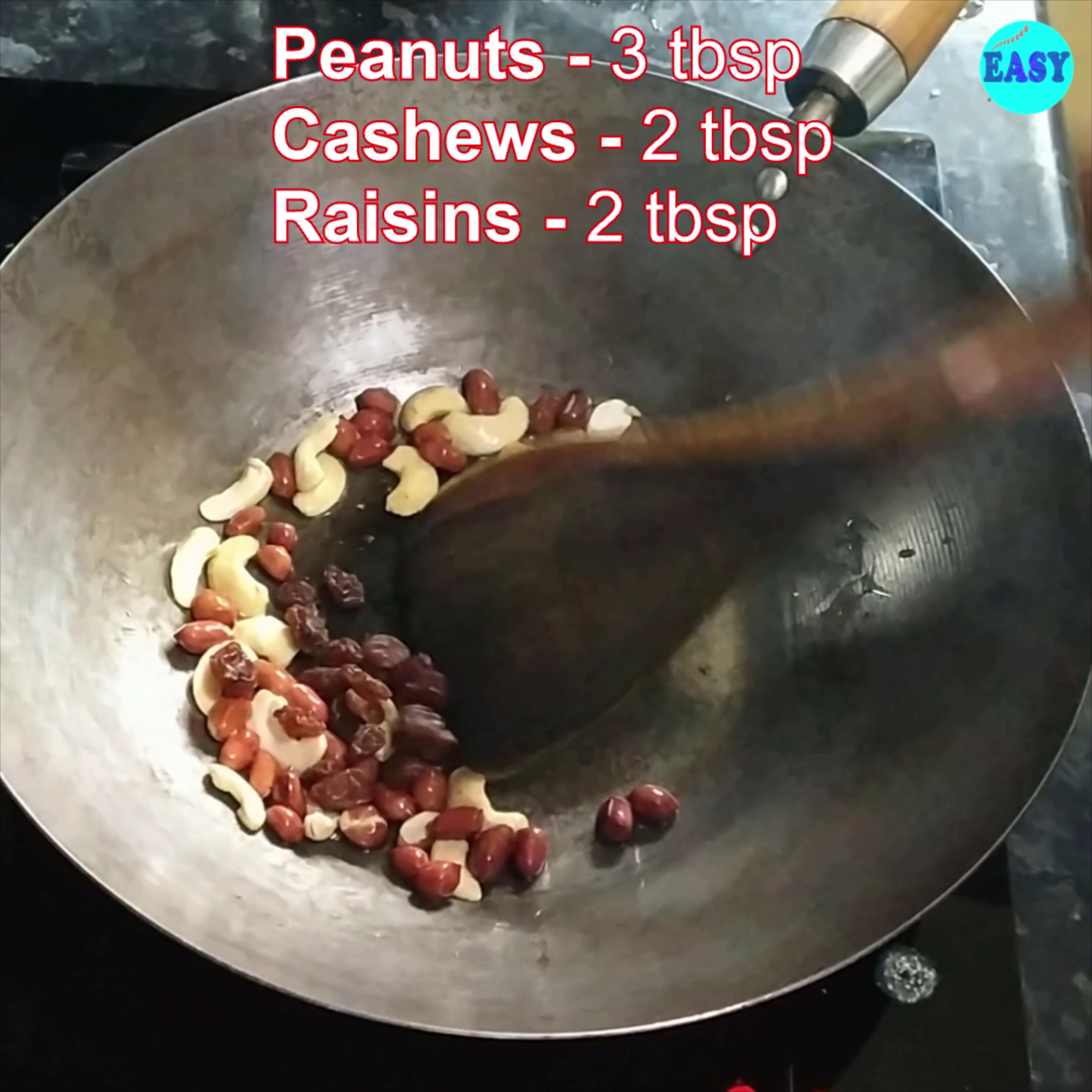 Step 4 - Heat 1 tbsp oil in a pan on medium flame, add peanuts and after few seconds add cashew nuts and raisins and fry them. 
