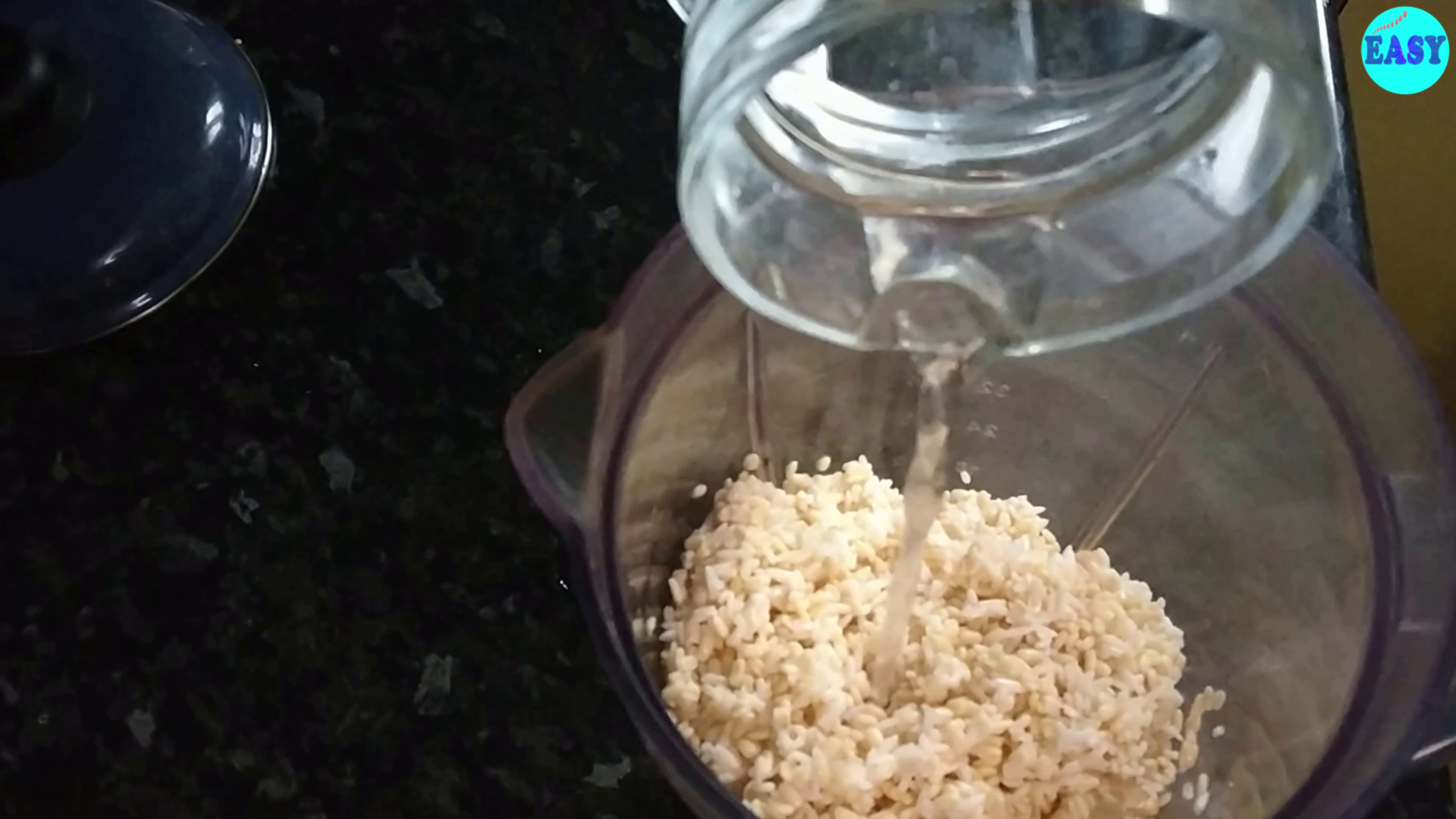 Step 2 - Transfer the soaked urad dal and rice to a mixer jar and blend it with a little bit of water to make a coarse paste. Make sure you use the minimal quantity of water for grinding.