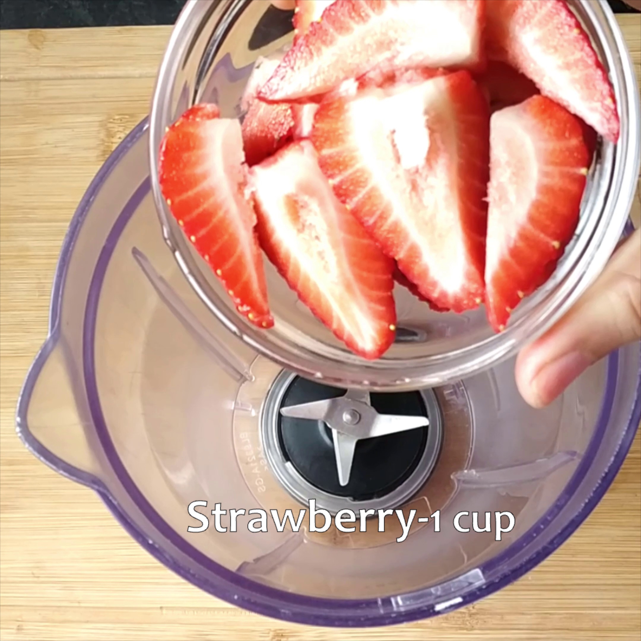 Step 1 - Wash and pat dry the strawberries. Remove the top and cut the strawberries into halves. Place them in a blender jar.