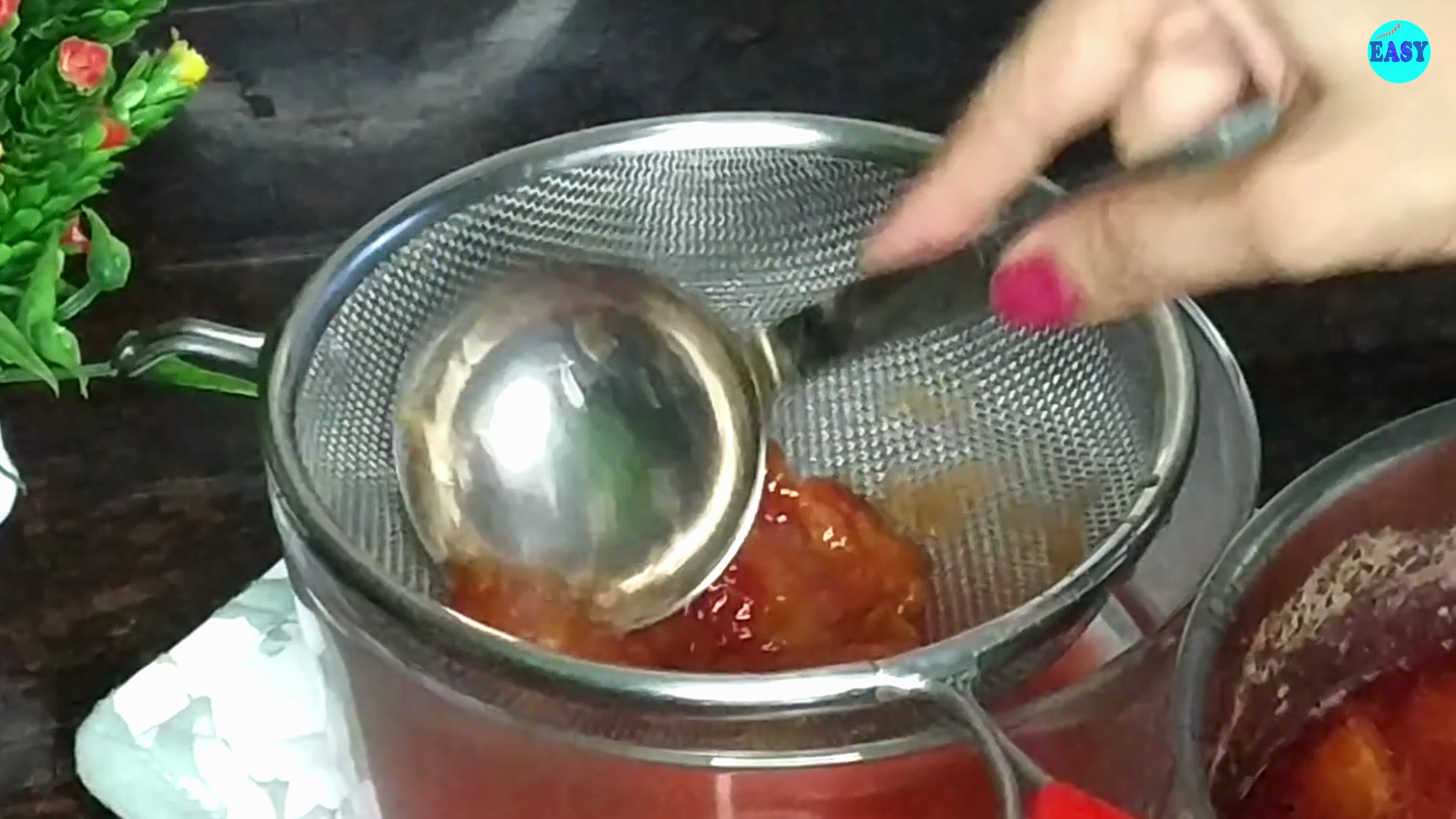 Step 5 - Pass the mixture through a sieve to separate the juice from the stones and peels.