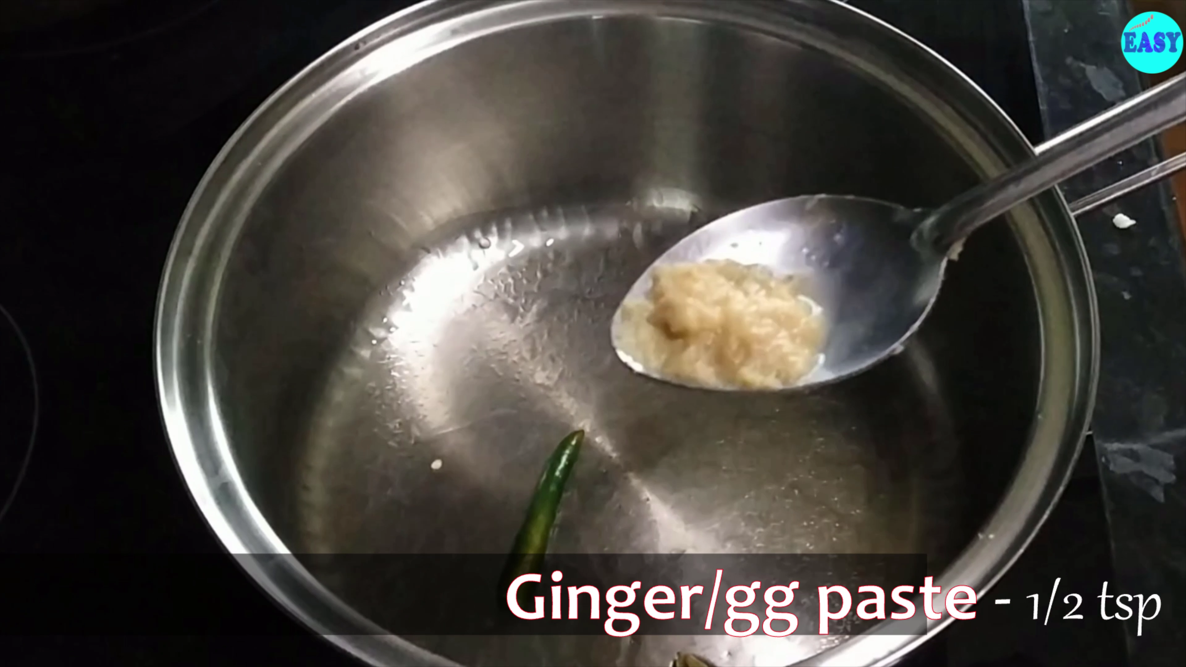Step 2 - Heat a pan and add oil or ghee, then add green cardamom, green chilli and ginger paste. 