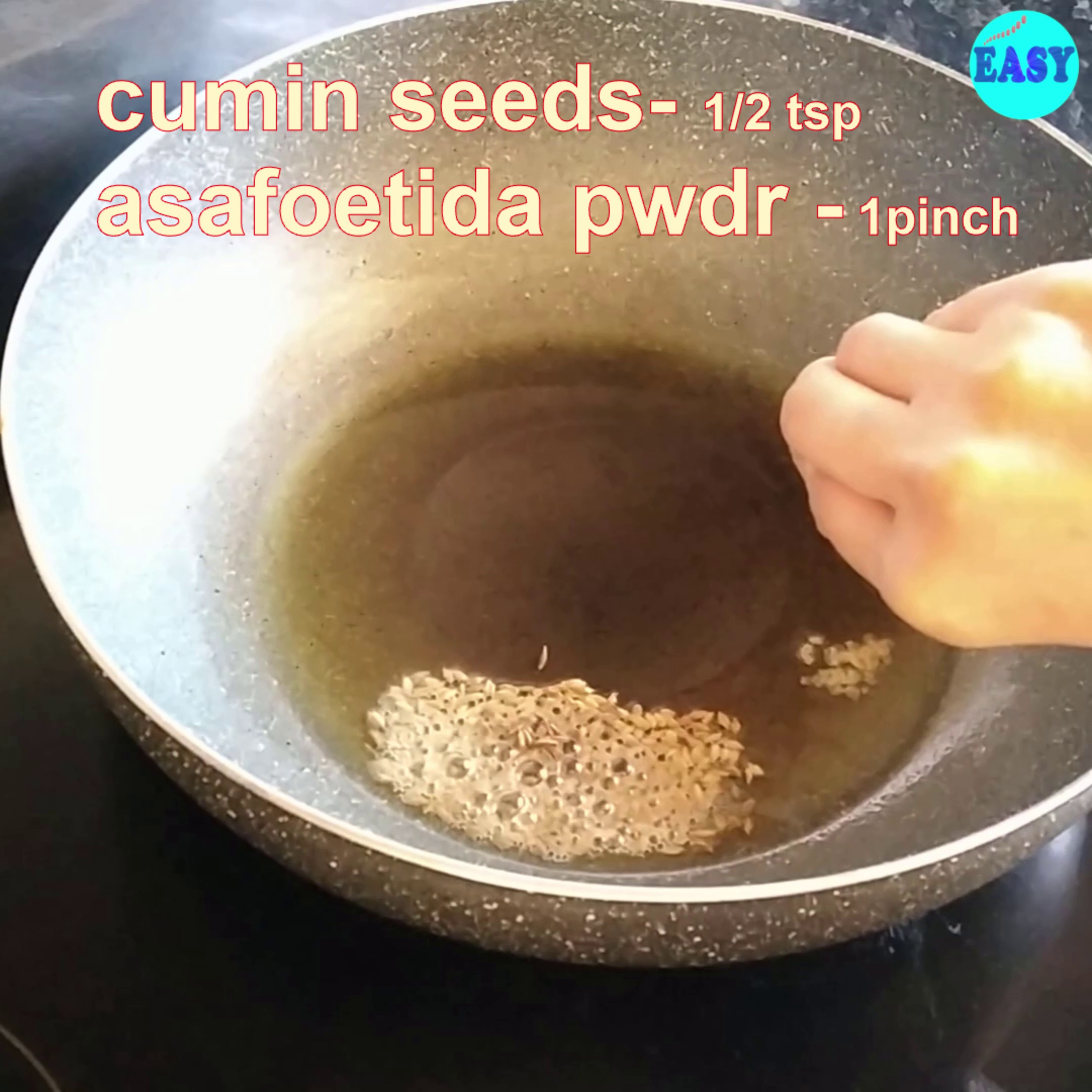 Step 4 - Heat oil in a heavy bottom pan or kadai, add cumin seed and asafoetida (hing).