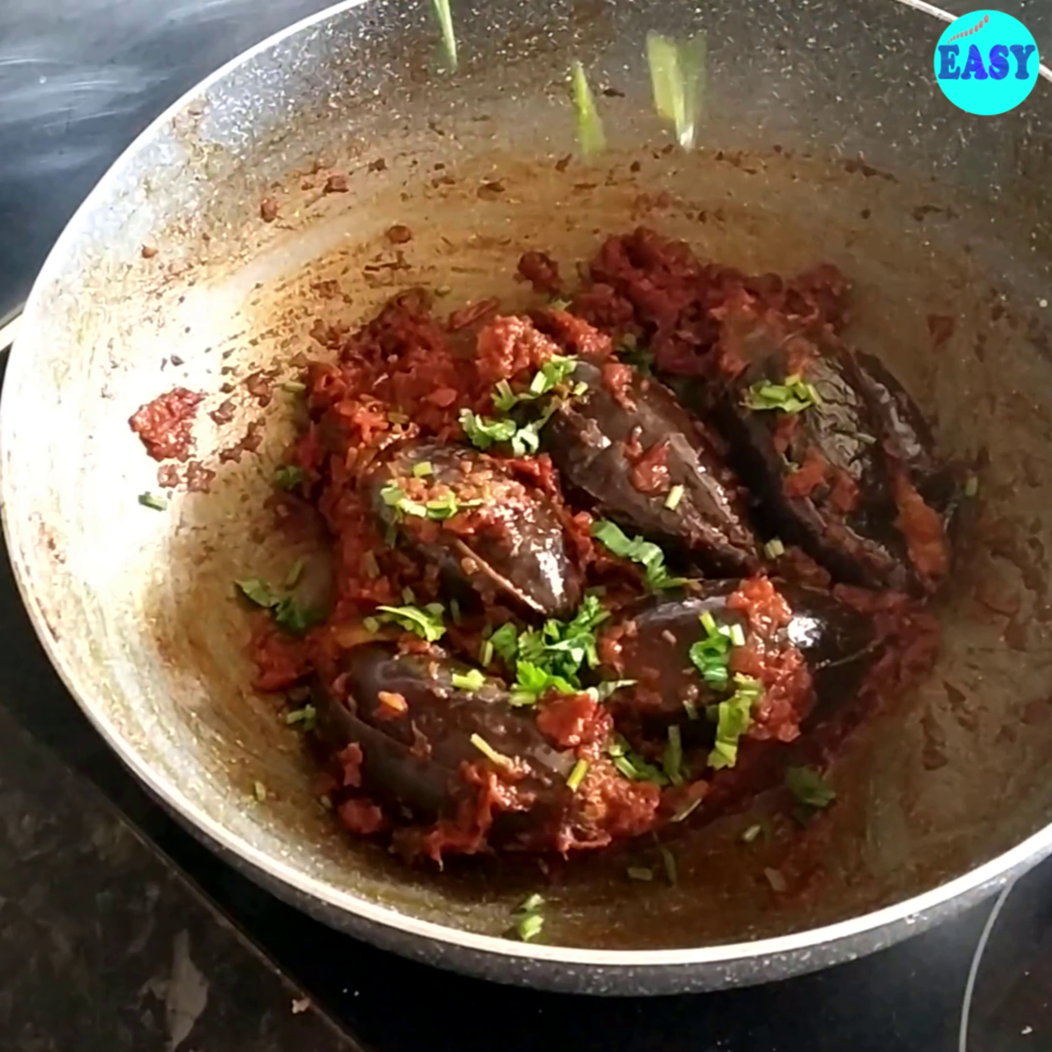 Step 12 - Once brinjals are tender switch of the flame and add chopped coriander leaves.