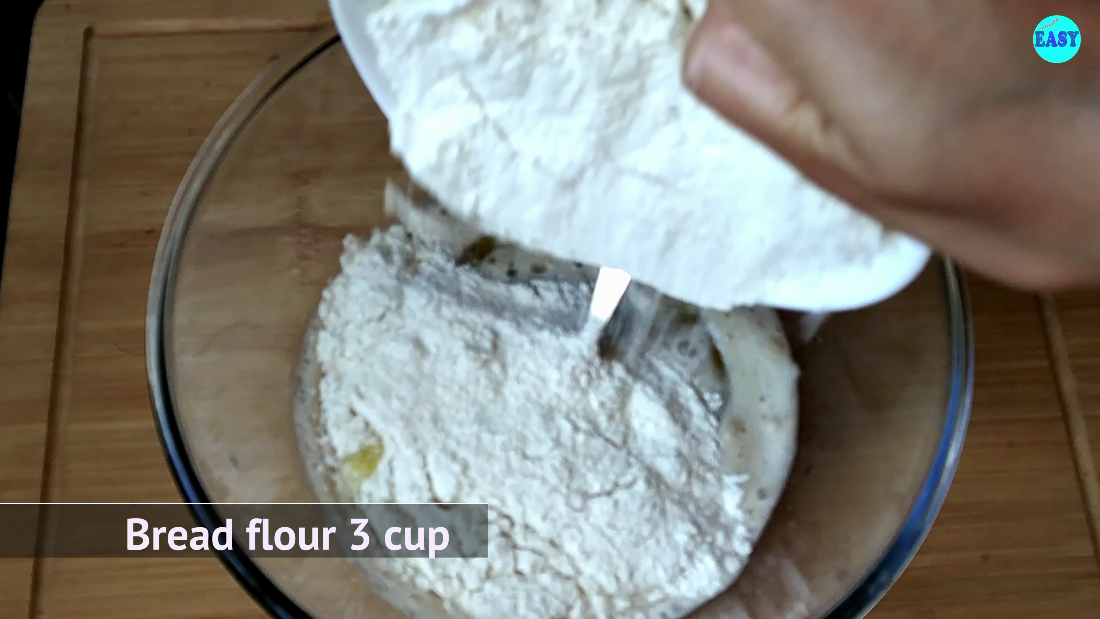 Step 2 - Once the mixture turns frothy add the olive oil, flour and salt, and mix until a dough forms.