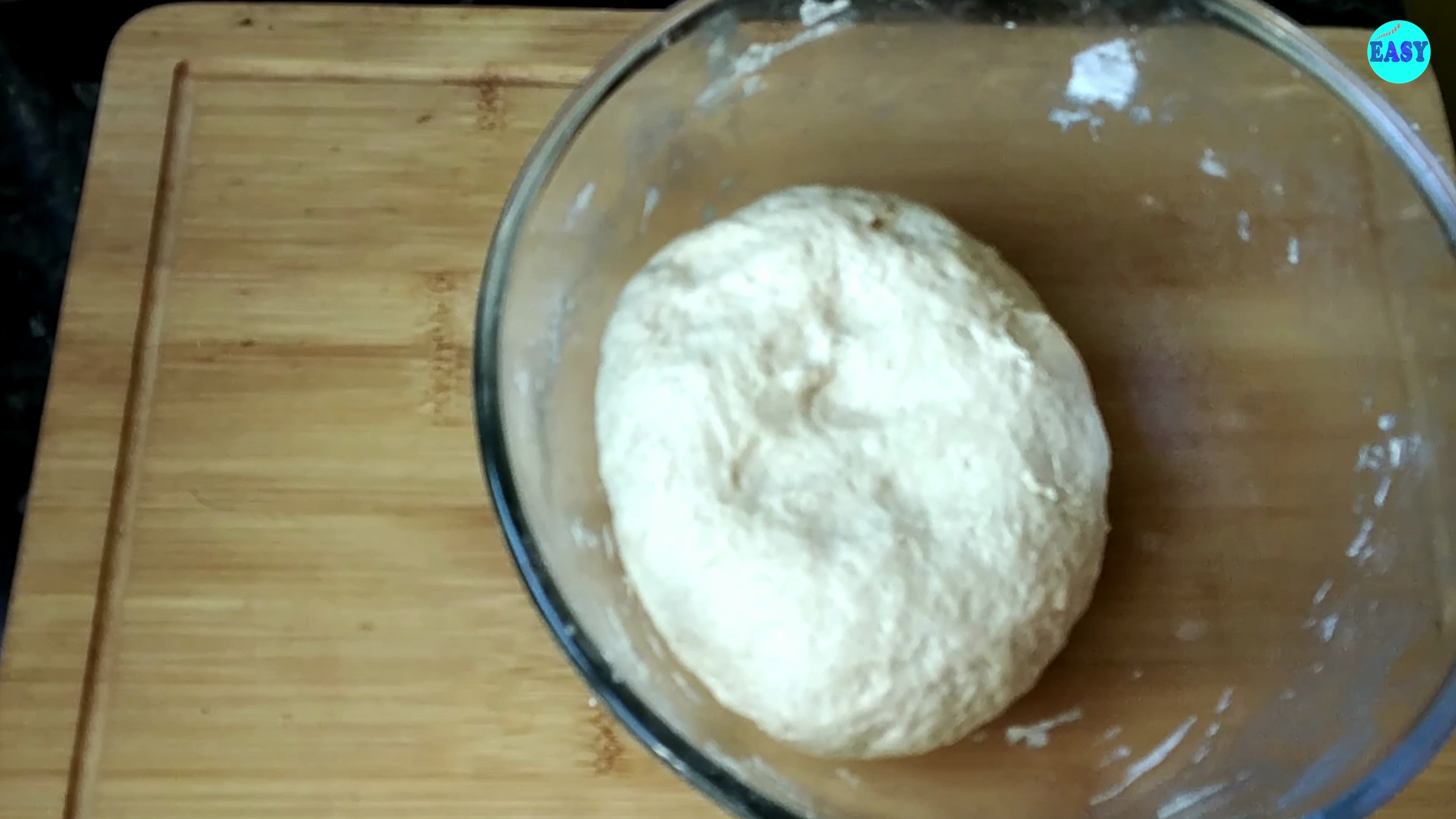 Step 4 - Place the dough in a greased bowl, cover it, and let it rise in a warm place for about an hour.