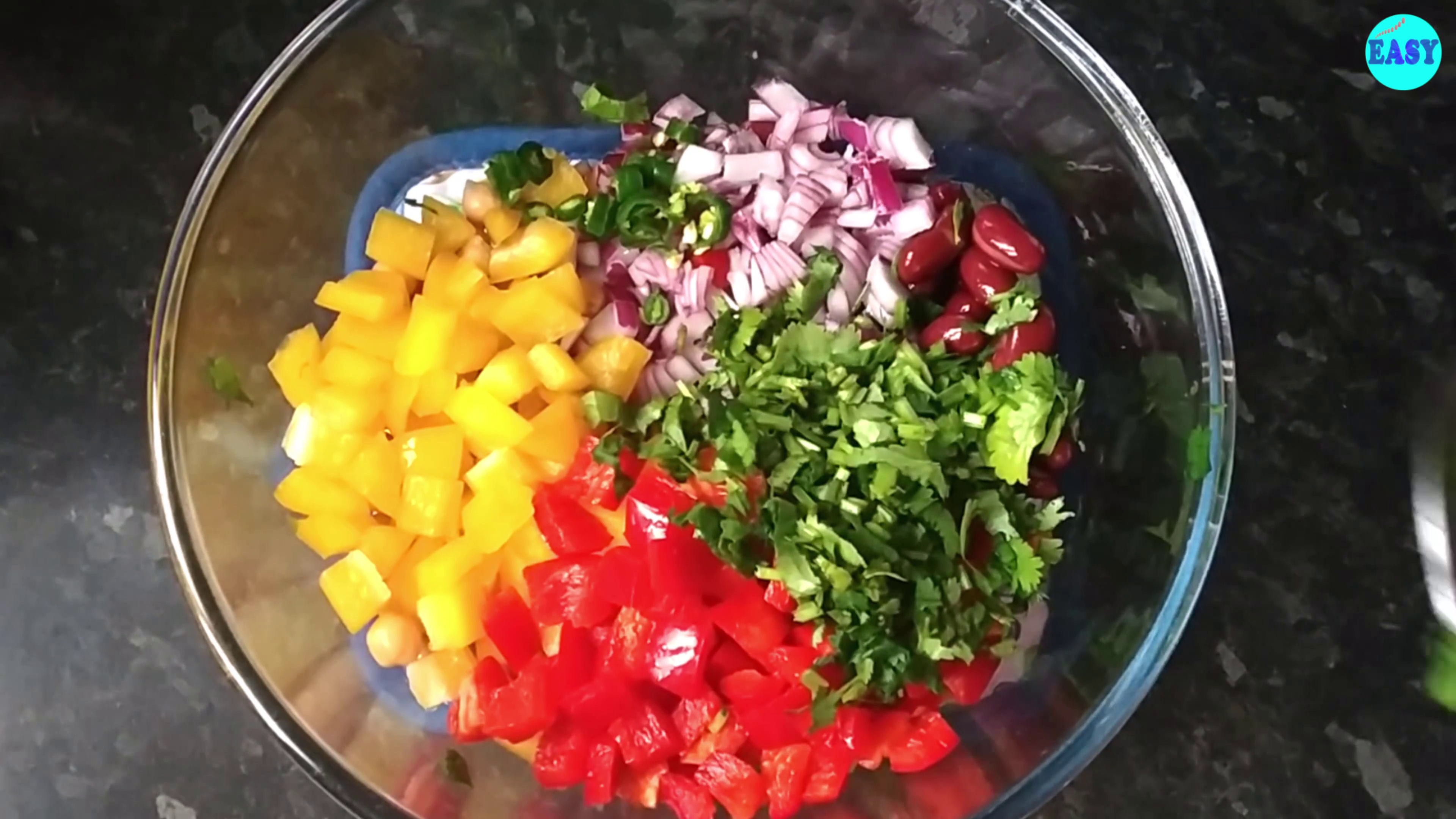 Step 1 - In a large mixing bowl, combine beans, chickpeas, corns, onions, cilantro and bell peppers.